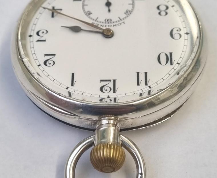 Longines pocket watch with top wind and time change in a silver case with London import hallmark for c1927. Signed white enamel dial with black Arabic hours and gilt hands with subsidiary seconds dial at 6 o/clock. Swiss signed 15 jewel jewelled lever movement with split bi-metallic balance and overcoil hairspring and numbered 4996586 with that number also repeated on the 'AB' case back.