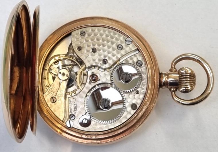 Swiss made unsigned half hunter pocket watch in a Dennison gold plated case with top wind and time change. Black Roman hours on the outer case and internal white enamel dial with black hours and blued steel hands with a subsidiary seconds dial at 6 o/c. Swiss made 17 jewel 3 adjustments jewelled lever movement with split bi-metallic balance and overcoil hairspring with the Dennison case numbered 965337 - 29.