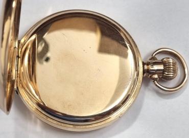 Swiss made Rolex half hunter pocket watch in an English 9ct gold case with top wind and time change and hallmarked for Chester c1927. Black Roman hours on the outer case and internal white enamel dial with black numeric hours and blued steel hands with a subsidiary seconds dial at 6 o/c. Swiss made signed Rolex jewelled lever movement with split bi-metallic balance and overcoil hairspring with engine turned decoration with case back numbered 8693.