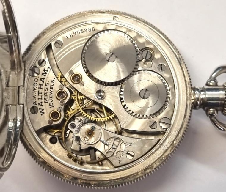 American Waltham fob/pocket watch with top wind and time change in a Dennison silver case hallmarked for Bristol c1912. White enamel dial with black Roman hours and gilt hands with a subsidiary seconds dial at 6 o/clock. AWW Waltham signed 15 jewel jewelled lever movement with micro-adjuster, split bi-metallic balance and overcoil hairspring and numbered 16953888 with the case back numbered 60994.