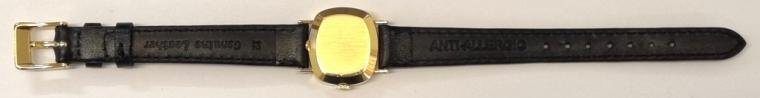 Ladies Rolex Orchid wrist watch in an 18K gold case with Swiss proof marks on a black leather strap with gilt buckle. Signed champagne coloured dial with baton hour markers and matching black hands. Swiss Rolex signed 18 jewel jewelled lever calibre 1400 hand wind movement with signed and numbered case back.