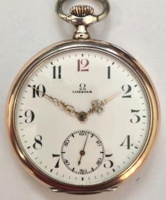 Swiss Omega open face pocket watch c1900 with top wind and time change in a 0.800 silver case with Swiss proof marks and gilt edging to bezel and case back. Signed white enamel dial with black Arabic hours and red '12' with ornate gilt hands and subsidiary seconds dial at 6 o/clock. Swiss Omega signed jewelled lever movement calibre 19LB with split bi-metallic balance and overcoil hairspring, numbered 6009698 with signed case back numbered 6799260.