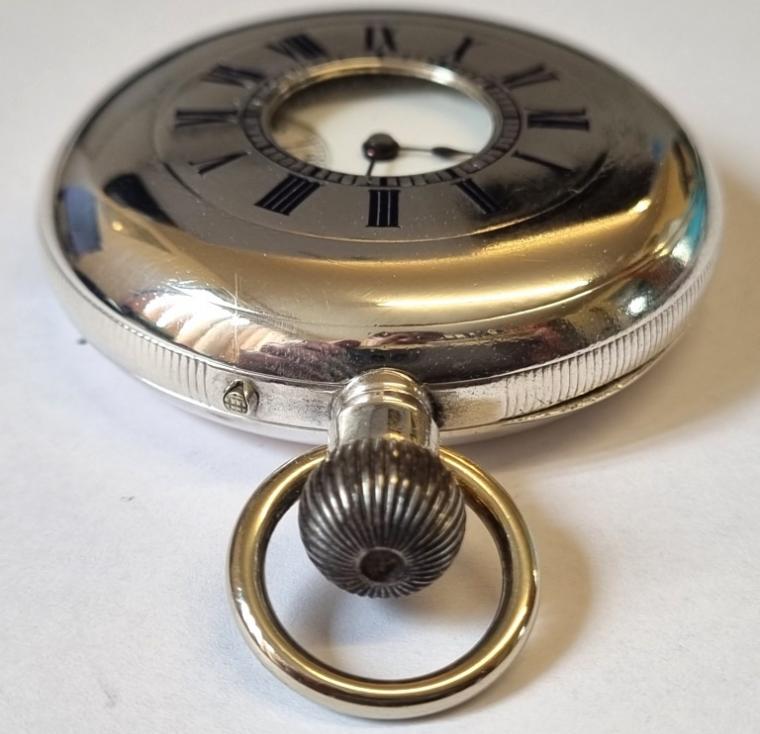 Swiss C19th half hunter pocket watch in a silver case with top wind and pin set time change with makers mark 'JS' to case and under dial. Black Roman hours on the outer case and internal white enamel dial with black Roman hours and blued steel hands with subsidiary seconds dial at 6 o/c. High quality Swiss jewelled lever movement with wolf teeth winding gear with movement and silver case numbered 62667 and case dust cover bearing an 1884 presentation inscription.