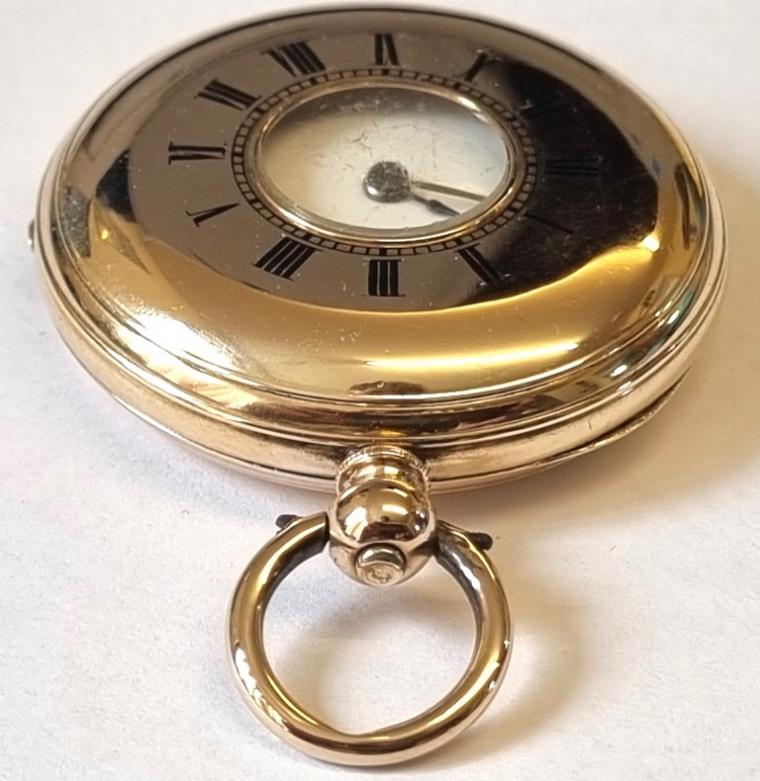 Swiss Stauffer, Son & Co of La Chaux-de-Fonds half hunter fob pocket watch in a 14K gold case with key wind and time change c1880. Black Roman hours on the outer case and internal white enamel dial with black Roman hours and blued steel hands with subsidiary seconds dial at 6 o/c. Signed Swiss key wound cylinder movement with case back numbered 66352 and bearing a decorative external monogram inscription.