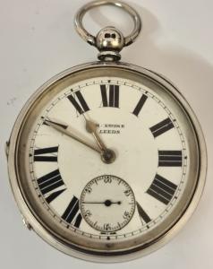 English full plate lever pocket watch by William Erhardt, retailed by H.Stone of Leeds in a silver case hallmarked for Birmingham c1904, signed 'WE' and numbered 534900. Key wind and time change with white enamel dial with black Roman hours and silvered hands with subsidiary seconds dial. Back plate signed 'Warranted English Lever.' and numbered 534900 with full plate lever movement with decorated cock piece and split bi-metallic jewelled balance. Case Diameter - 56mm.