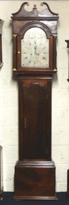 English 8 day bell striking, weight driven and pendulum regulated longcase clock by Charles Penny of Bristol circa 1790. Substantial flame mahogany veneered casework with swan neck pediment with gilt disc and finial decoration and fluted pillars with lower weight and pendulum access door. Signed silvered ornately inscribed dial plate with floral decoration and black Roman hours with black steel hands and subsidiary seconds dial with lower date display aperture. Dimensions - Height 87.5", Width 20.5", Depth 8.5".