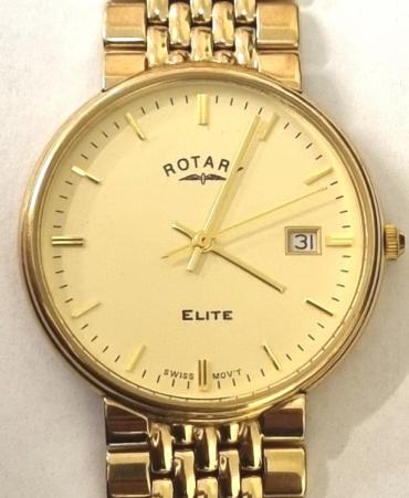 Swiss Rotary Elite gents 9ct all gold quartz dress watch with integral 'rice grain' Rotary bracelet. Signed champagne coloured dial with polished gilt baton hours and matching hands with centre seconds and a date display at 3o/c. Case diameter - 33mm, bracelet length - 180mm, overall weight (including movement and crystal) - 56 grams.