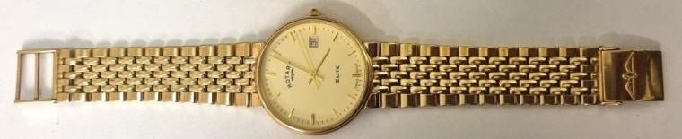 Swiss Rotary Elite gents 9ct all gold quartz dress watch with integral 'rice grain' Rotary bracelet. Signed champagne coloured dial with polished gilt baton hours and matching hands with centre seconds and a date display at 3o/c. Case diameter - 33mm, bracelet length - 180mm, overall weight (including movement and crystal) - 56 grams..