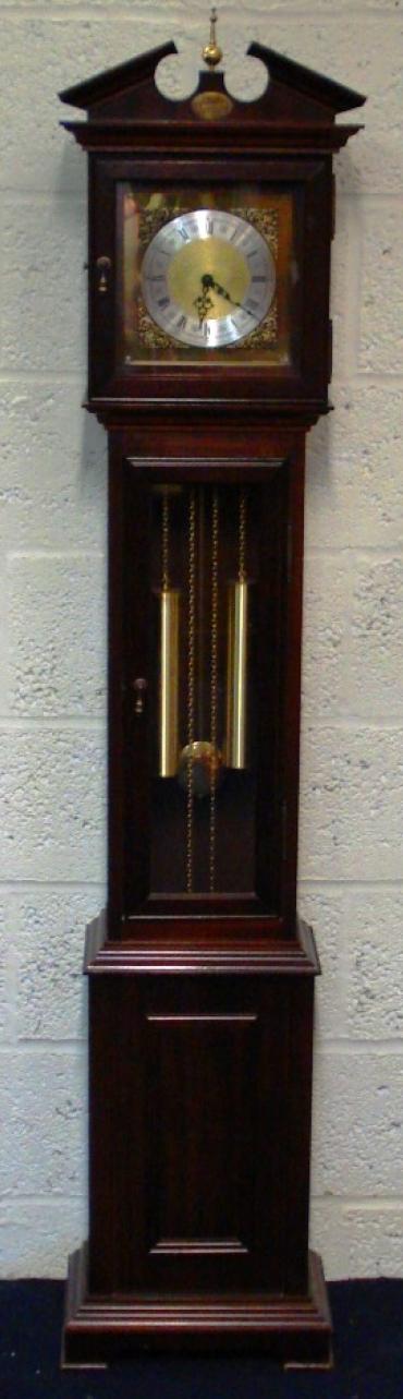 Modern mahogany finished, 8 day, weight driven striking grandfather longcase clock with German movement by Franz Hermle and Son. Decorative brass face, silvered chapter ring, brass spandrels, black hands and black roman hour markers.