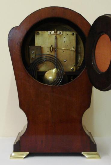 English mahogany cased 8 day bracket clock by the Astral Clock Company, circa 1920. Dome topped case with boxwood inlay and decorative marquetry plaque and gilded bracket feet. Circular gilt brass bezel with convex glass over convex silvered dial with black roman hours and black steel hands. Good quality square brass spring driven, pendulum regulated, gong striking movement with the 'Astral Coventry' back stamp and numbered #41398