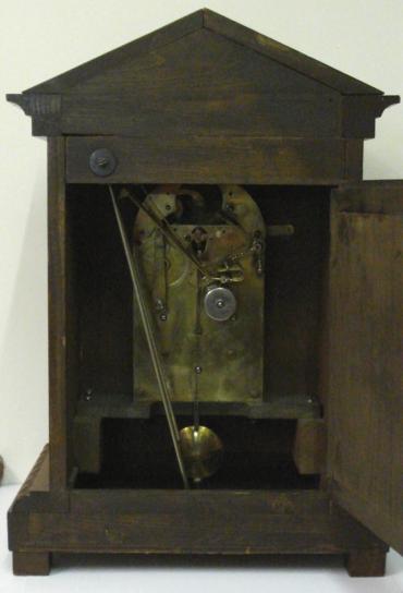 German oak cased 8 day Westminster chime bracket clock by Junghans circa 1900. Architectural case with carved decorated top and plinth, with wooden ball feet. Carved wooden door with heavily chamfered glass over acid etched brass dial plate with Chime / Silent and Slow / Fast controls at the top. White silvered chapter ring with black roman hours and ornate blued steel hands. Square brass spring driven, pendulum regulated movement, stamped with the Junghans touch mark.