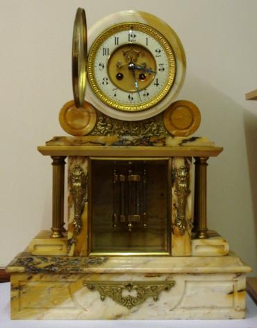 French 8 day white marble cased mantel clock with applied gilt decoration and side columns. Round clock case with gilt bezel and chamfered glass over white enamel chapter ring with matt gilt centre, black gothic hours and ornate blued steel hands. Visible Brocot escapement and slow / fast adjuster at 12 o'clock. Good quality circular brass spring driven movement, maker unknown, numbered #1339, with count wheel strike on a bell and a mercury pendulum.