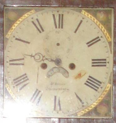 Clock for sale for restoration:- English 8 day oak and mahogany cased bell striking longcase grandfather clock by W. Evans of Shrewsbury circa 1820. Scrolling swan neck pediment with cross banding and shell motif inlay together with  fluted brass capped side columns. Original glass over painted and gilded dial with floral decoration and black roman hours, date aperture and seconds dial. Lacks minute and seconds hands, weights and pendulum.
