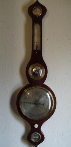 Arnoldi of Gloucester, oak cased mercury barometer with onion style top and bottom, and silvered dials: - hygrometer, thermometer, convex mirror, barometer, an ivory hand adjuster, and bubble level gauge.