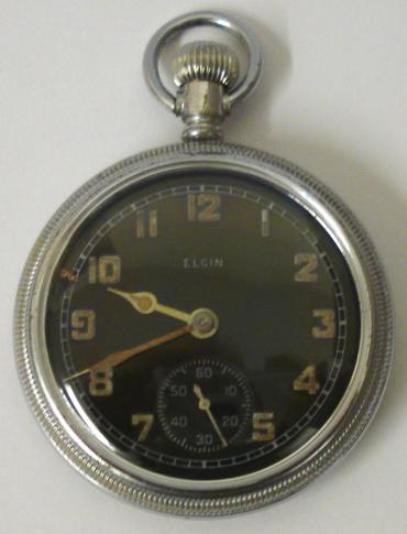 Elgin National Watch Co. WW2 military pocket watch. Black enamel dial with old luminous arabic hours, matching hands and subsidiary seconds dial at 6 o/c. Base metal case with screw on front and back with 9 jewel jewelled lever movement numbered #41230358 and dating from 1943. The case back is worn but bears the broad arrow mark and is numbered A97134.
