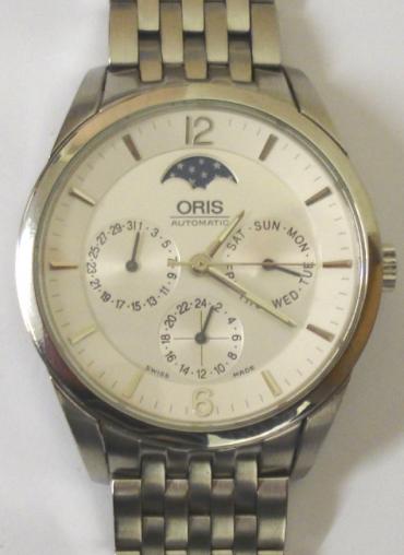 Oris 7506 XL All Stainless Steel automatic wrist watch with integral s/steel bracelet. Sapphire crystal over a white dial with silvered baton hour markers with matching hands and sweep seconds with Moon Phase, Day, Date and 24hr display dials. Swiss made Oris 581 17 jewel incabloc movement with screw on case back, water resistant to 30 metres.
