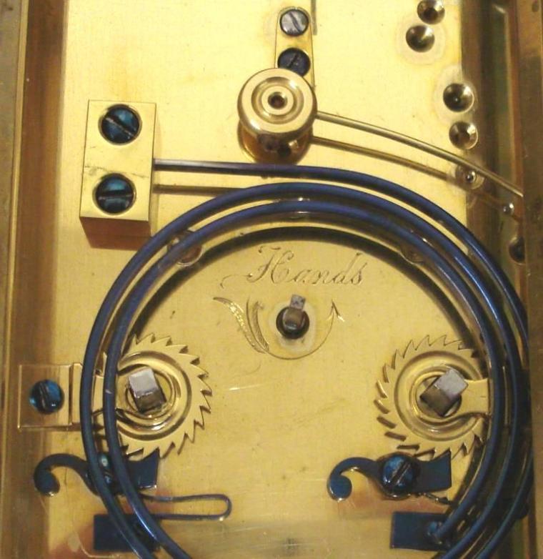 French gilt brass and 5 glass, 8 day strike / repeat carriage clock circa 1880 by Henri Jacot. Corniche case with chamfered glass panels throughout, white enamel dial with black Roman hours and minute track and blued steel hands. Back plate with Jacot arrow and numbered #6702 below a contemporary silvered jewelled lever escapement. 'Hidden' oval Henri Jacot stamp applied internally to the back of the dial plate. Height - 7.25" Width - 3.75" Depth - 3.25".