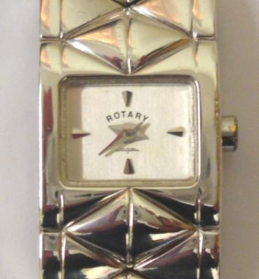 Ladies modern Rotary quartz dress watch in a silver case with integral Birmingham import hallmarked bracelet circa 1998. Signed white dial with polished quartered hour markers and polished silver hands. Signed case back carrying the Birmingham hallmarks and stamped Sterling Silver.