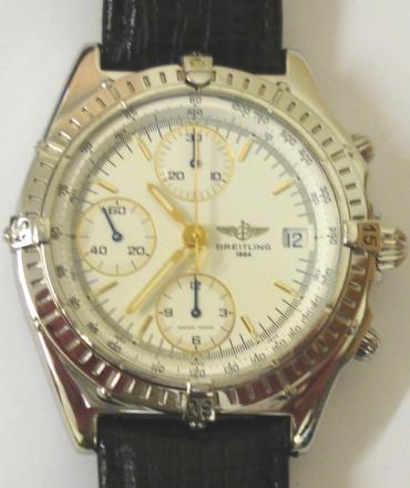Breitling Automatic Chronograph in a stainless steel case on an original black leather strap. Sapphire crystal over a white dial with gilt and luminous baton hour markers and matching hands with a subsidiary seconds dial and date display at 3 o/c. 12 hour chronograph time recording via the sweep seconds hand and subsidiary hours and minutes dials. Screw down crown and case back with signed 25 jewel calibre 7750 Valjoux movement complete with all original paperwork and boxes.