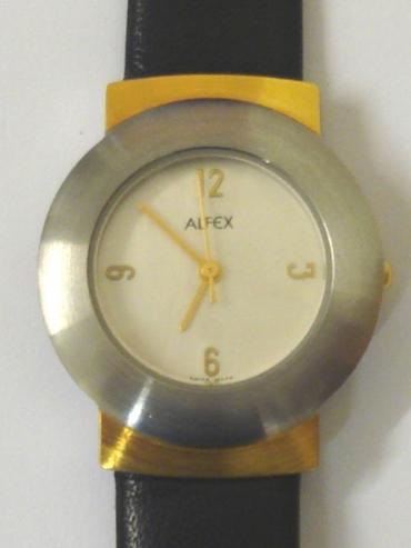 Modern quartz Swiss made wrist watch by Alfex. Brushed stainless steel and gilt case water resistant to 30 metres with a polished stainless steel back and on an original Alfex black leather strap. Silvered dial with gilt quartered hour markers and matching hands with gilt seconds hand.