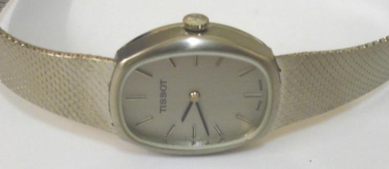 Tissot manual wind wrist watch circa 1970 housed in a stainless steel case with integral stainless steel adjustable bracelet. Brushed silver dial with polished silver and black hour markers and matching black hands. Signed Tissot calibre 2180 jewel lever incabloc movement numbered #21141 with signed case back numbered #10933.