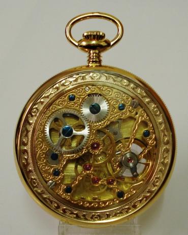 New gold plated open face pocket watch by the Rapport Company. White dial with gold coloured hands and black painted hour markers, subsidiary seconds dial at 6 o'clock and visible balance. Mechanical 17 jewel skeletonised movement, with stem wind and time adjust. Original box and gold plated watch chain with 'T' bar and bow snap.