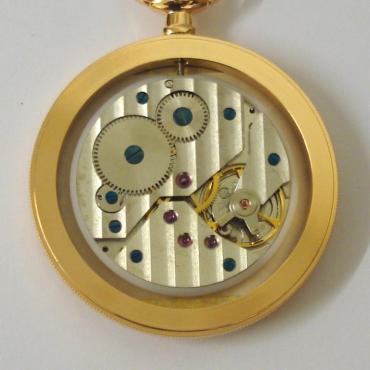 New gold plated open face pocket watch by the Rapport Company with paperwork and box. Top wind and time change 17 jewel mechanical movement with white dial, black roman hour markers, black painted hands and a subsidiary seconds dial.