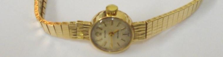 Ladies Rolex Precision 9ct gold manual wind wrist watch with integral gold bark effect bracelet. Silvered dial with gilt baton hour markers and matching hands. Signed Rolex 18 jewel calibre 1400 movement with Rolex case numbered #33379 with London hallmark for 1967.