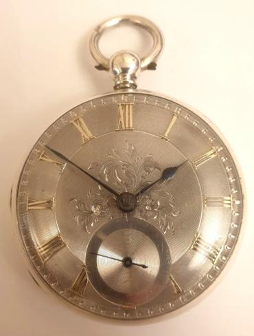 English silver cased key wound fusee lever pocket watch with London hallmark for circa 1850. Silver engine turned and floral engraved dial with gilt Roman hours and blued steel spade hands with subsidiary seconds dial at 6 o/c. Decoratively engraved cock piece with diamond end stone and unsigned back plate numbered #11091 with the number repeated on the case interior.
