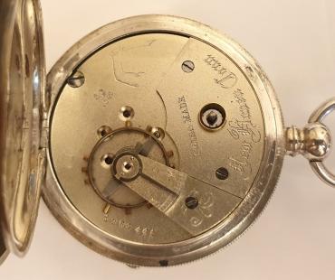 Swiss silver cased cylinder pocket watch late C19th made for the New Haven Watch Co. Connecticut. Key wind and time change with signed white enamel dial and black Roman hours with blued steel hands and subsidiary seconds dial. The silver case stamped 0.800 together with a Swiss 1882-1934 proof mark and numbered #2027. Swiss jewelled cut bi-metallic balance movement with cylinder escapement and back plate signed and numbered #1264441 and bearing a raised arm holding a scimitar touch mark.