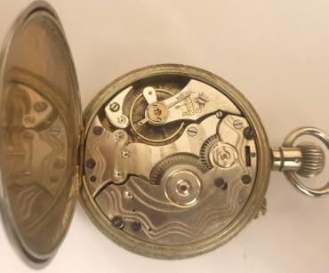 Swiss early c20th nickel cased pocket watch with top wind and rocking bar time change. White enamel dial signed Vibrona, with black Roman hours and blued steel hands with subsidiary seconds dial at 6 o/c. Plain pin lever movement with a jewelled balance and machine decorated back plate.