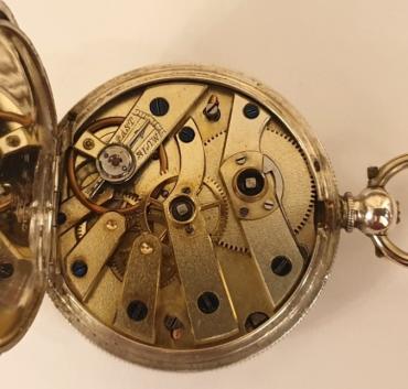 Swiss unsigned silver cased small pocket / fob watch late C19th / early C20th. Key wind and time change with floral decorated white enamel dial and black Roman hours with gilt hands, the well engraved silver case stamped 800M together with a Swiss 1882-1934 proof mark and numbered #60622 with initial 'L'. Undecorated split bar movement with cylinder escapement and jewelled balance.