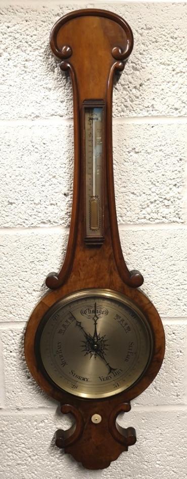 C19th mahogany cased mercury wheel barometer with decorative edge moulding. Circular gilt brass bezel with flat glass over a silvered dial with black inches of mercury pressure index and blued steel pressure indicating hand with a brass history marker which is manually adjusted by the lower ivory coloured wheel. Complete with a separate silvered dial Fahrenheit thermometer.  Dimensions: - Height 1200mm, width 330mm.