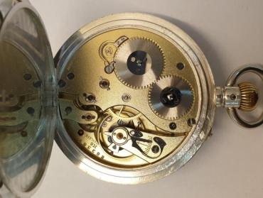Swiss silver cased pocket watch by S&Co with IWC Peerless signed movement and London import hallmark for c1917. Top wind and rocking bar time change with white enamel dial and black Roman hour markers and blued steel hands with subsidiary seconds dial at 6 o/c. Swiss jewelled lever movement with micro regulator and split bi-metallic balance with overcoil hairspring, numbered 663387 H6, the case maker 'CN' and numbered 718739.