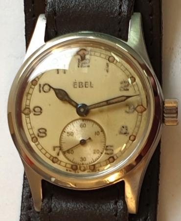 Swiss ex-military Ebel manual wind wrist watch c1940 in a stainless steel case with black leather strap. Light coloured dial with aged black Arabic hours with luminous markers and blued luminous insert steel hands with a subsidiary seconds dial at 6 o/c. Signed Ebel calibre 99 jewelled lever movement with case back numbered 999901.