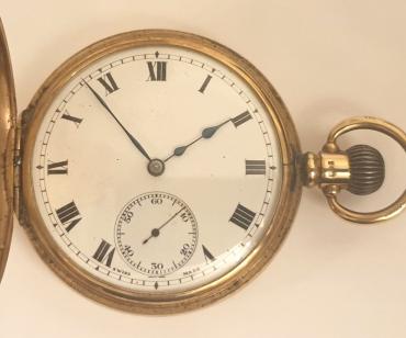 Swiss half hunter pocket watch in a 9ct gold Dennison case hallmarked for Birmingham c1921 with top wind and time change. External black Roman chapter ring on the case outer, internal white enamel dial with black Roman hours and blued steel hands and a subsidiary seconds dial at 6 o/c. Swiss jewelled lever movement with overcoil hairspring and split bi-metallic balance jewelled to the centre, with gold case numbered 223851 and complete with plush lined retail case.