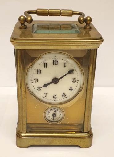 French gilt brass and 5 glass, 8 day miniature alarm carriage clock time piece circa 1900, maker unknown. Obis casework with chamfered glass panels throughout and gilt brass masked white enamel dial with black Arabic hours and black steel hands together with lower alarm time set indicator dial. Plain brass movement numbered 30105 with original cylinder escapement.     Height - 3.5" Width - 2.5" Depth - 2.25".
