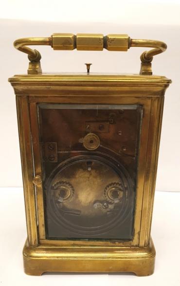 French gilt brass and 5 glass, 8 day carriage clock circa 1900, striking and repeating on a gong. Obis casework with chamfered glass panels throughout and gilt brass masked white enamel dial with black Arabic hours and black steel hands together with gilt dial centre. Plain brass movement with original silvered lever escapement platform.    Height - 6" Width - 3.75" Depth - 3.25".
