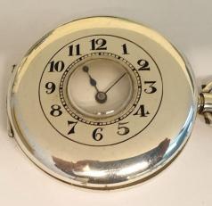 Swiss half hunter pocket watch in a silver case with a London import hallmark for 1918 with top wind and time change. External black Arabic chapter ring on the outer case, internal white enamel dial with black Arabic hours and blued steel hands with a subsidiary seconds dial at 6 o/c. Swiss 17 jewel unsigned jewelled lever movement with overcoil hairspring and split bi-metallic balance.