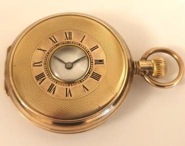Swiss unsigned half hunter pocket watch c1900 in a gold filled, coin edging case with top wind and time change. External black Roman chapter ring on the outer case, internal white enamel dial with black Roman hours and blued steel hands with a subsidiary seconds dial at 6 o/c. Standard Swiss unsigned 15 jewel jewelled lever movement.