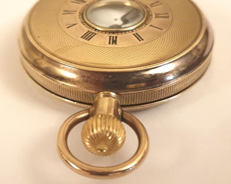 Swiss unsigned half hunter pocket watch c1900 in a gold filled, coin edging case with top wind and time change. External black Roman chapter ring on the outer case, internal white enamel dial with black Roman hours and blued steel hands with a subsidiary seconds dial at 6 o/c. Standard Swiss unsigned 15 jewel jewelled lever movement.