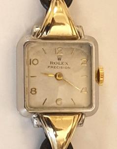 Ladies Rolex Precision manual wind cocktail dress watch circa 1940, in a bi-colour stainless steel and gold case on a brown leather cordette strap with gilt fittings. Signed Rolex white dial with gilt Arabic hours and matching polished gilt hands. Swiss signed Rolex Precision 17 jewel movement with Patented Super Balance.