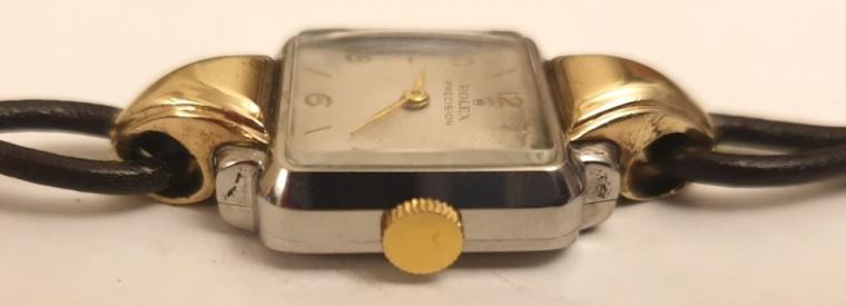 Ladies Rolex Precision manual wind cocktail dress watch circa 1940, in a bi-colour stainless steel and gold case on a brown leather cordette strap with gilt fittings. Signed Rolex white dial with gilt Arabic hours and matching polished gilt hands. Swiss signed Rolex Precision 17 jewel movement with Patented Super Balance.