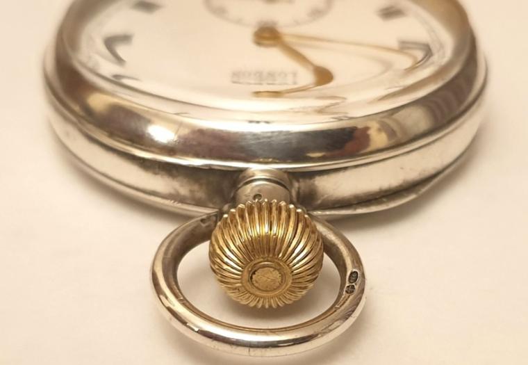 Swiss J.W.Benson pocket watch in a silver case with a London import hallmark for 1919. Top wind and time change with white enamel J.W.Benson, London signed dial with black Roman hours and gilt hands with subsidiary seconds dial at 6 o/c. Swiss 15 jewel jewelled lever escapement with bi-metallic balance in a .925 silver case numbered 1880.