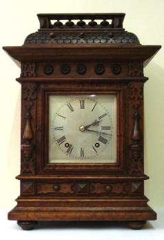 8 day Winterhalder and Hofmeier Ting Tang mantel clock circa 1900. Substantial architectural mahogany case with half turned pillars and other applied decoration throughout. Square wooden door with flat glass over heavily silvered brass dial plate with engraved black roman hours and minute track and ornate blued steel hands. Good quality square brass ting tang spring driven pendulum governed movement stamped 'D.R.Patent' (Deutsches Reich Patent) and 'W&H Sch' (Winterhalder & Hofmeier Schwarzenbach).  Dimensions: Height - 17", Width - 10.5", Depth - 7". 