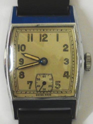 Vintage gents wrist watch with manual wind 15 jewel Swiss made movement circa 1940, housed in polished stainless steel cushion shaped case with a stainless steel back and a black leather strap. Silver coloured dial with luminous Arabic hour markers and blued steel hands with luminous inserts, together with a subsidiary seconds dial at 6 o/c. 