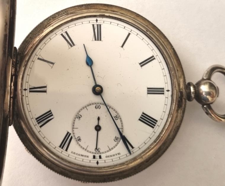 Late C19th Swiss half hunter pocket watch by Le Comte of Geneva in a silver case with key wind and time change. External blue Roman hours on the outer case and internal white enamel dial with black Roman hours and blued steel hands with subsidiary seconds dial at 6 o/c. Swiss signed Le Comte, Geneve split bar jewelled lever escapement in a silver case bearing the Le Comte mark and numbered 40275.