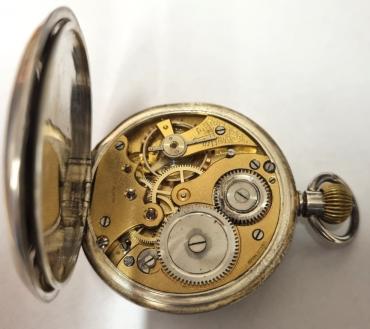 Swiss silver cased pocket watch bearing a London import hallmark for c1911. Top wind and time change with a white enamel dial with hairline cracking . Black Roman hours with blued steel hands and subsidiary seconds dial at 6 o'clock. Swiss 15 jewel jewelled lever movement unsigned but with the case back marked 'SD' and numbered 38124 & 38134.