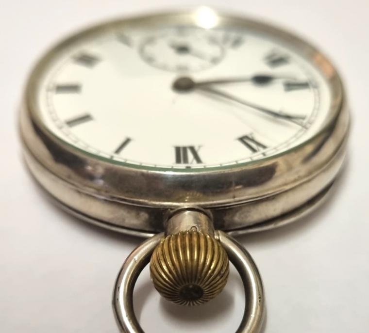 Swiss silver cased pocket watch bearing a London import hallmark for c1911. Top wind and time change with a white enamel dial with hairline cracking . Black Roman hours with blued steel hands and subsidiary seconds dial at 6 o'clock. Swiss 15 jewel jewelled lever movement unsigned but with the case back marked 'SD' and numbered 38124 & 38134.