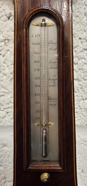 English mid to late C19th mahogany cased mercury wheel barometer with hygrometer and mercury Fahrenheit thermometer. Swan neck pediment with brass finial and boxwood stringing throughout the lower casework. Circular brass bezel with convex glass over a silvered dial engraved with black inches of mercury pressure index and a blued steel pressure indicating hand with a gilt history marker. The alcohol spirit level indicator at the case bottom signed for 'R.D.Gant' of 'Woodbridge'. Height - 38" and width - 10".